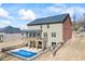 View of the backyard featuring a pool, covered patio, and second-story deck with a beautiful home exterior at 3316 Quarter Horse Ln, Conyers, GA 30013