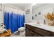 Bathroom featuring a modern vanity, white sink, and bright blue shower curtain at 3316 Quarter Horse Ln, Conyers, GA 30013