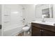 Bathroom featuring a combination tub and shower with white fixtures and a modern vanity at 3316 Quarter Horse Ln, Conyers, GA 30013