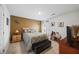 Bedroom with accent wall, bedside table, TV, and bench, naturally lit by a window at 3316 Quarter Horse Ln, Conyers, GA 30013