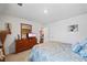 Bedroom with carpet, simple art, a dresser, and neutral decor with a view to the hallway at 3316 Quarter Horse Ln, Conyers, GA 30013