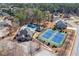 Aerial view showcasing neighborhood amenities with tennis courts, pool, and lush landscaping in the community at 3316 Quarter Horse Ln, Conyers, GA 30013