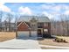 Inviting brick two-story home with an attached two-car garage, manicured lawn, and lush landscaping at 3316 Quarter Horse Ln, Conyers, GA 30013