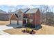 Two-story brick home with manicured front lawn, a two-car garage, covered entry, and overcast sky at 3316 Quarter Horse Ln, Conyers, GA 30013