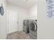 A laundry room complete with modern washer and dryer machines at 3316 Quarter Horse Ln, Conyers, GA 30013