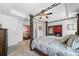 Elegant main bedroom with a four-poster bed and a view of a fireplace in an adjacent seating area at 3316 Quarter Horse Ln, Conyers, GA 30013