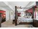 Beautiful main bedroom featuring a four-poster bed and a glimpse into a cozy seating area with a fireplace at 3316 Quarter Horse Ln, Conyers, GA 30013