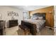 Main bedroom with brown and gray decor, a large bed, side table, and bench at 3316 Quarter Horse Ln, Conyers, GA 30013