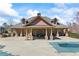 A covered in-ground pool sits in front of an outdoor covered patio with brick columns and seating at 3316 Quarter Horse Ln, Conyers, GA 30013