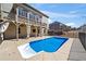 In-ground pool with covered patio, ceiling fans and curtains in backyard is the ideal space for relaxation and entertainment at 3316 Quarter Horse Ln, Conyers, GA 30013