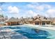 An in-ground pool covered for the winter, adjacent to the community clubhouse and poolhouse at 3316 Quarter Horse Ln, Conyers, GA 30013