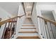 A modern staircase with dark metal railings, and white paneled walls at 3316 Quarter Horse Ln, Conyers, GA 30013