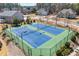 An aerial view showing the community tennis courts surrounded by a black metal fence at 3316 Quarter Horse Ln, Conyers, GA 30013