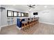 Modern basement bar features a long countertop, seating for six, and built-in shelving at 4080 Glen Hill Ne Way, Marietta, GA 30066