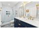 Well-lit bathroom with double sink vanity, framed mirrors and tiled walk-in shower at 4080 Glen Hill Ne Way, Marietta, GA 30066