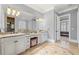 Elegant bathroom with double vanity, granite countertops, decorative mirrors, and access to the main bedroom at 4080 Glen Hill Ne Way, Marietta, GA 30066