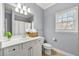 Well-lit bathroom features a white vanity, a framed mirror, and a window that provides natural light at 4080 Glen Hill Ne Way, Marietta, GA 30066