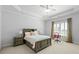 Spacious bedroom boasts a tray ceiling, neutral tones, and a comfortable sitting area at 4080 Glen Hill Ne Way, Marietta, GA 30066
