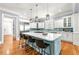 Gourmet kitchen with large island, stainless steel appliances, white cabinetry, and stylish pendant lighting at 4080 Glen Hill Ne Way, Marietta, GA 30066