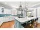 Bright kitchen featuring a large center island with white countertop, modern appliances, and stylish pendant lighting at 4080 Glen Hill Ne Way, Marietta, GA 30066