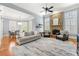 Inviting living room featuring a stone fireplace, large windows with plantation shutters, and an elegant dining area at 4080 Glen Hill Ne Way, Marietta, GA 30066