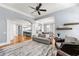 Open-concept living room showcasing modern decor, hardwood floors, and seamless flow to kitchen and dining areas at 4080 Glen Hill Ne Way, Marietta, GA 30066