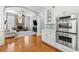 Open floor plan showcasing the kitchen with stainless steel appliances, and a living room with a stone fireplace at 4080 Glen Hill Ne Way, Marietta, GA 30066