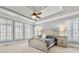 Serene main bedroom with tray ceiling, plantation shutters, neutral colors, and lots of natural light at 4080 Glen Hill Ne Way, Marietta, GA 30066