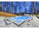 Backyard pool featuring lounge chairs, a spa, and a surrounding fence at 4080 Glen Hill Ne Way, Marietta, GA 30066