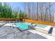 Beautiful backyard pool and spa area featuring modern pavers, lounge chairs, and a surrounding wooden fence at 4080 Glen Hill Ne Way, Marietta, GA 30066