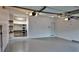 Spacious garage with epoxy floor coating, garage door, storage shelving, and side door at 93 Richmond Way, Villa Rica, GA 30180