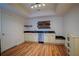 Modern kitchenette with granite countertops, stainless steel dishwasher, and floating shelves in this stylish home at 93 Richmond Way, Villa Rica, GA 30180