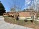 Exterior shot of the backyard featuring landscaping and a home with a wooden deck at 248 Arnold Ave, Marietta, GA 30066