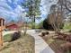 Landscaped backyard featuring a stone patio and a red shed in the background at 248 Arnold Ave, Marietta, GA 30066