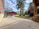 Backyard featuring a stone patio, landscaping, and a small red shed in the background at 248 Arnold Ave, Marietta, GA 30066