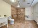 Accessible bathroom featuring a roll-in shower with grab bars and tiled walls and floors at 248 Arnold Ave, Marietta, GA 30066