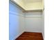 Walk-in closet with wood floors and storage shelves at 248 Arnold Ave, Marietta, GA 30066