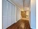 Hallway leading to a bathroom with accessibility features and white closets with louvered doors at 248 Arnold Ave, Marietta, GA 30066