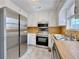 Eat-in kitchen featuring stainless appliances, double sink and ample white cabinets at 248 Arnold Ave, Marietta, GA 30066