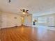 Open-concept living space featuring durable wood laminate flooring, a ceiling fan, and entrance to the kitchen at 248 Arnold Ave, Marietta, GA 30066