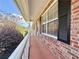 Brick ranch home with a covered front porch showing black shuttered windows and a white handrail at 248 Arnold Ave, Marietta, GA 30066