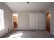 Neutral bedroom featuring plush carpet, and double door closet with bathroom access and natural light at 3572 Dexter Way, Marietta, GA 30062