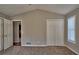 Spacious bedroom with vaulted ceiling, plush carpet, and double door closet with natural light from window at 3572 Dexter Way, Marietta, GA 30062