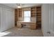 Bedroom featuring plush carpet, built-in shelving with desk, and double door closet with ceiling fan at 3572 Dexter Way, Marietta, GA 30062