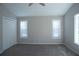 Neutral bedroom featuring plush carpet, and double door closet with natural light from two windows at 3572 Dexter Way, Marietta, GA 30062