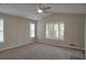 Bright bedroom featuring plush carpet, and natural light from three windows, ceiling fan and double door closet at 3572 Dexter Way, Marietta, GA 30062