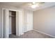 Neutral bedroom featuring plush carpet, and a closet with bi-fold doors along with a ceiling fan at 3572 Dexter Way, Marietta, GA 30062