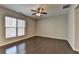 Bright bedroom features hardwood flooring, a ceiling fan, and a large window offering natural light at 68 Hardy Water Dr, Lawrenceville, GA 30045