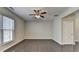 Spacious bedroom featuring hardwood flooring, a ceiling fan, and a large window for ample natural light at 68 Hardy Water Dr, Lawrenceville, GA 30045