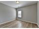 Cozy bedroom featuring hardwood floors, natural light, and a neutral color palette at 68 Hardy Water Dr, Lawrenceville, GA 30045